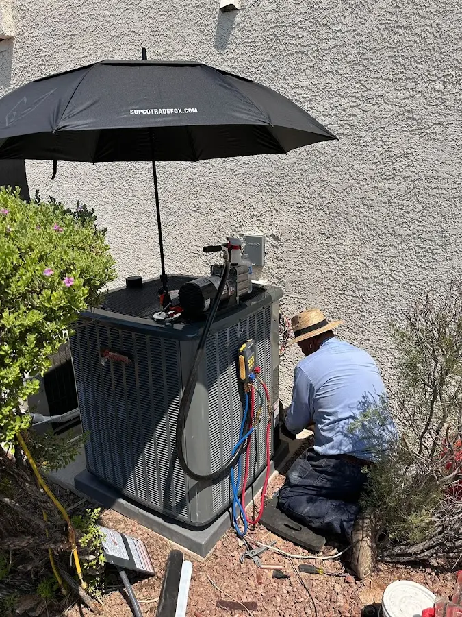 HVAC technician performing outdoor AC maintenance in Erwin